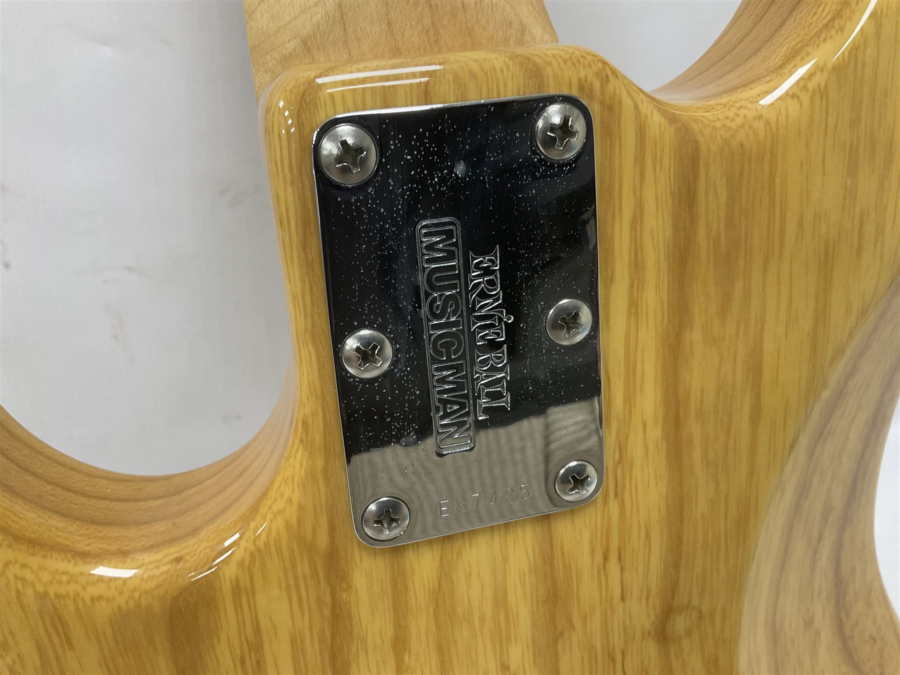 Ernie Ball Music Man Sting Ray 4 string bass guitar, in natural finish with roasted maple neck and tortoiseshell effect scratch guard, serial no 87485, in black Music Man hard case, guitar L114cm