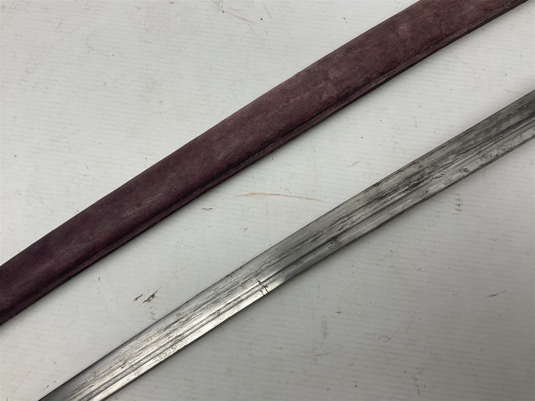 Copy of a WWII Japanese NCO sword, the 65cm slightly curving blade stamped with pseudo Japanese characters and cast brass simulated cord bound grip; in officer's leather bound field scabbard L97cm overall