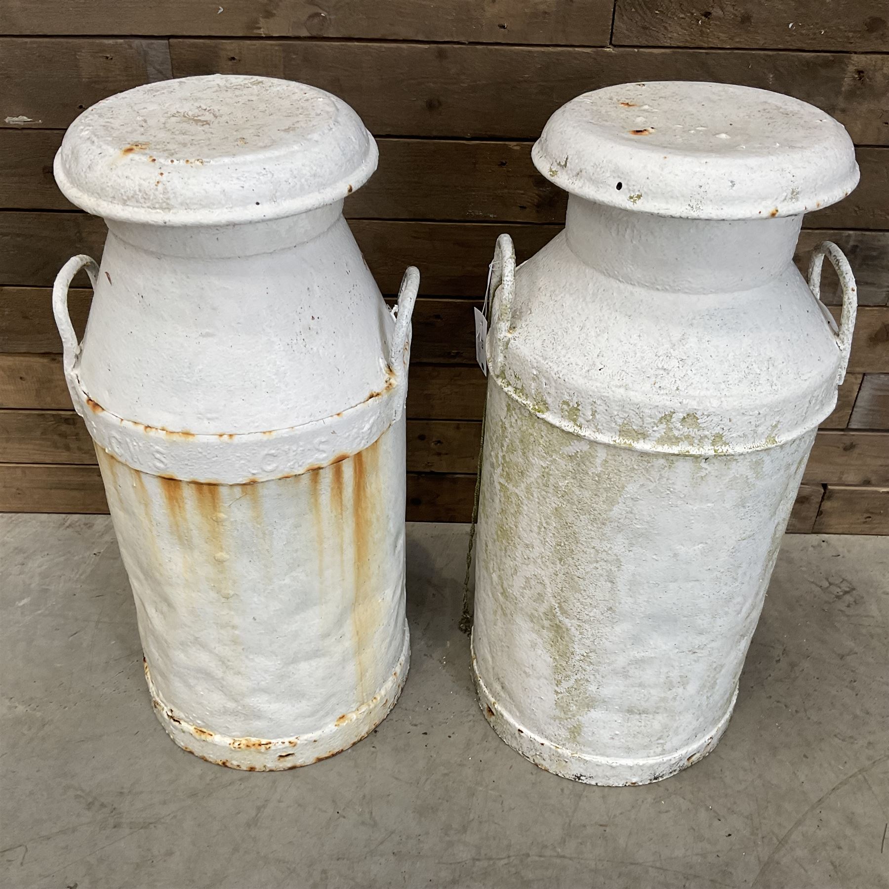 Two white painted milk churns with lids