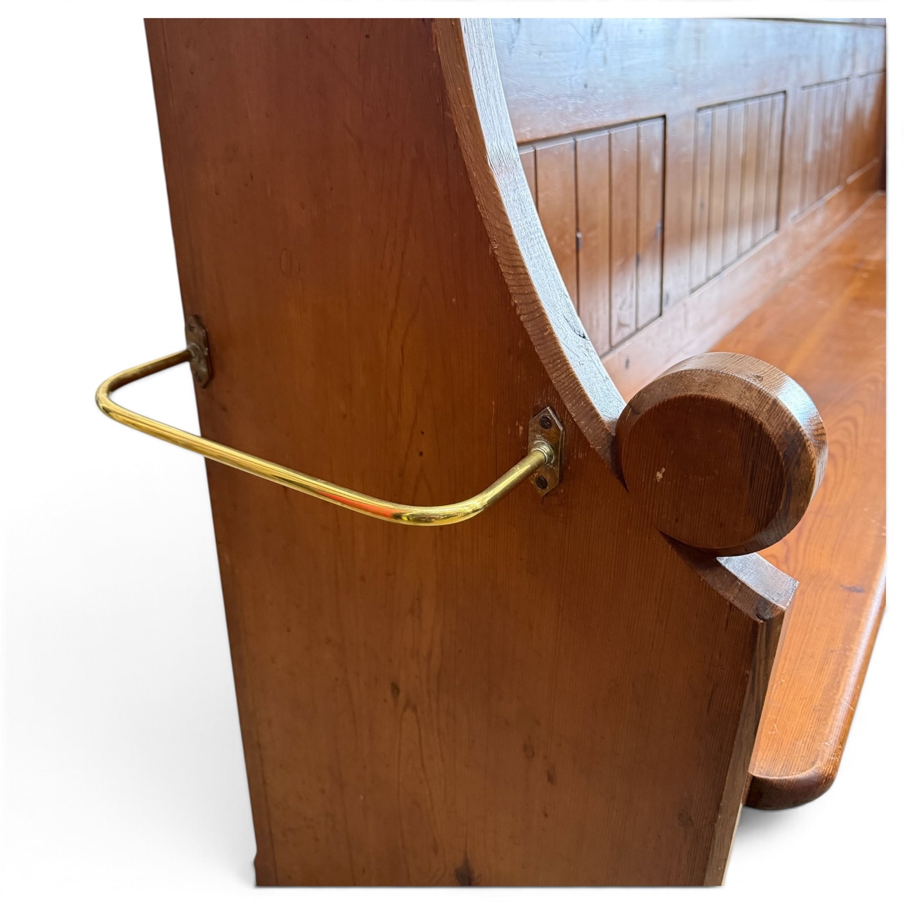 Early 20th century stained pine ecclesiastical church pew, the shaped end supports flanking slatted and panelled back, with black stencilled number '16' to the side