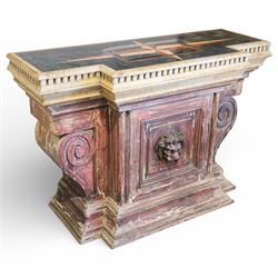 A 20th century Italian Neoclassical console table of monumental architectural form, inspired by Roman altar and sarcophagus prototypes; the rectangular marble top with dentil-moulded edge and polychrome geometric compass-star inlay, executed in contrasting marbles on a dark green ground, above a pedestal base of simulated stone finished in red porphyry-type tones, centred by a lion’s mask in relief and flanked by Ionic scroll volutes, raised on a stepped plinth base