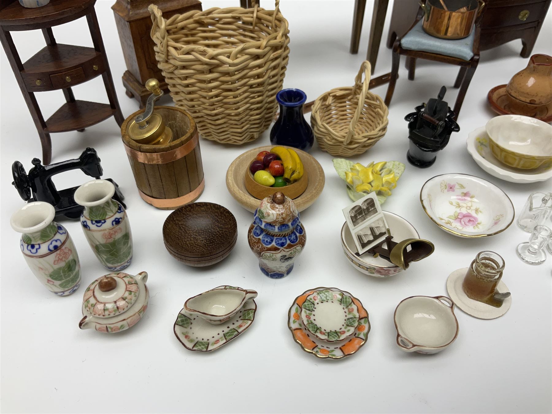 Collection of miniature dolls house furniture and accessories, to include long case clock, chest of drawers, tiled wash stand, ceramics and glass ware, mirror, baskets, etc 