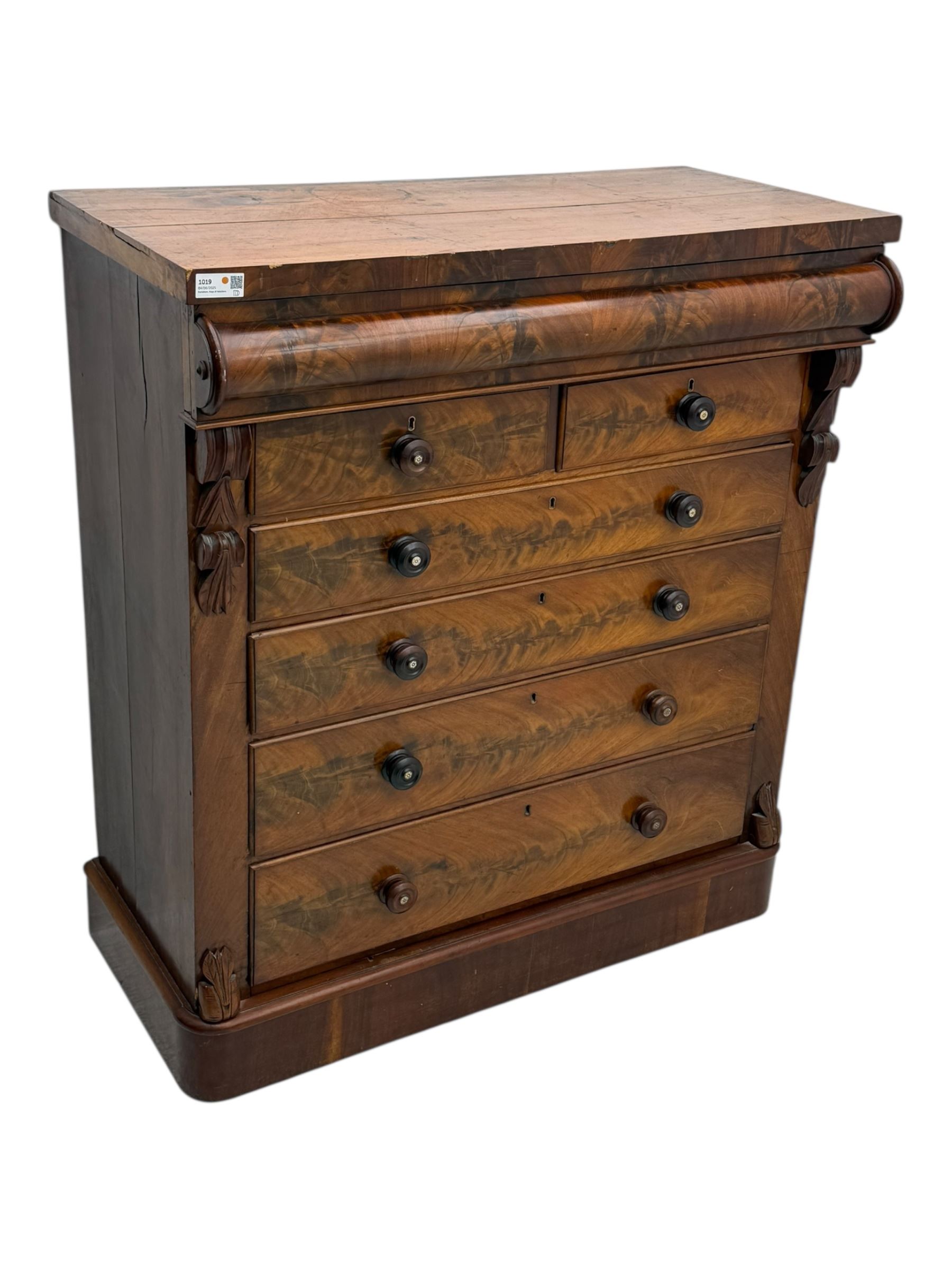 19th century flame mahogany Scotch chest, frieze long drawer above two short and four long graduating drawers, with turned knobs scrolled carved side bracket 