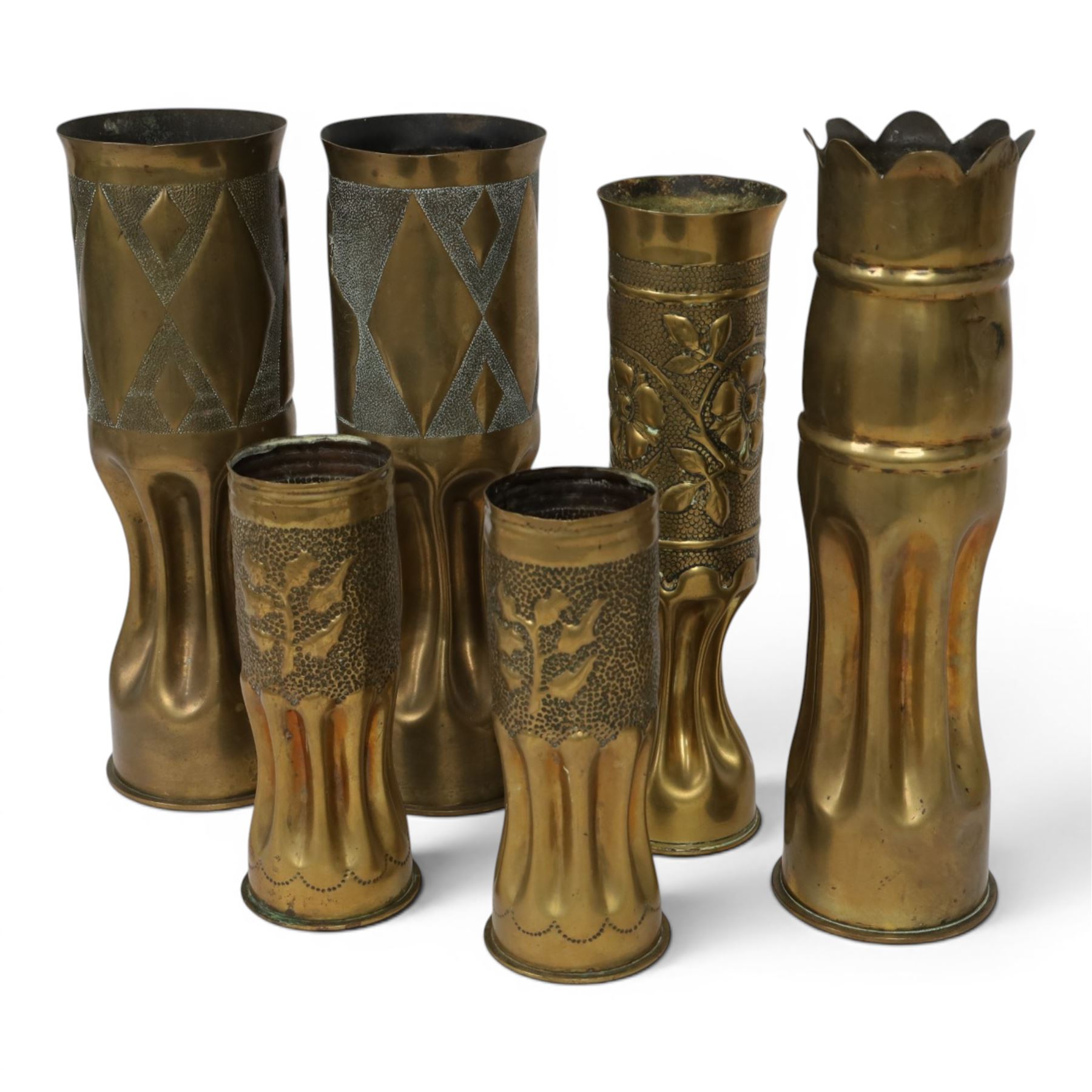 Pair of Second World War Trench Art M14 Shell Cases, each relief-decorated and engraved with a portrait of General de Gaulle, together with another pair decorated with lions and two others, largest H36cm 