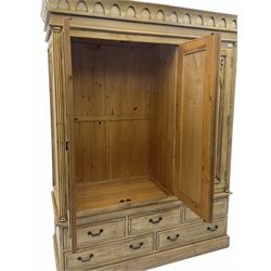 Polished pine triple wardrobe, fitted with centre mirror above five drawers