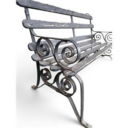 Coalbrookdale - rare pair of wrought iron and slatted wood garden benches, the twin wrought iron strapwork bench-ends formed of four scrolls over splayed feet, number 77 in the Coalbrookdale Castings Catalogue (see illustration)