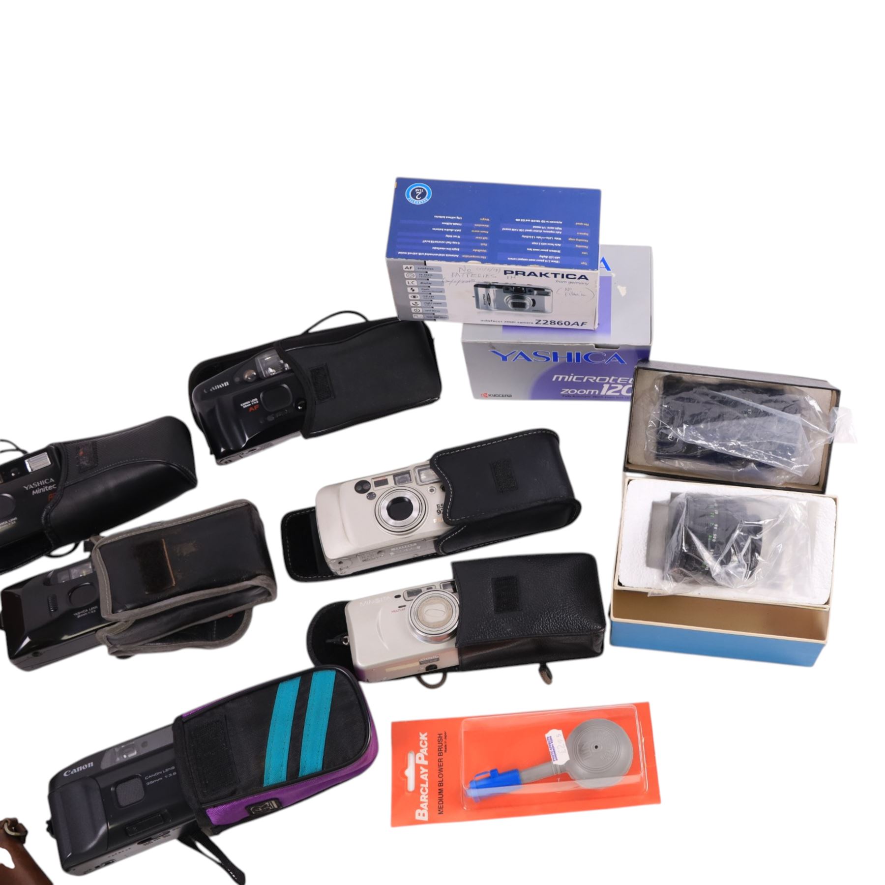 Collection of compact cameras, including Yashica, Minolta and Praktica examples, Boots binoculars, two Pentacon lenses and other accessories