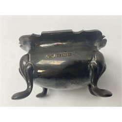 Modern two piece silver cruet set, comprising pepper shaker and open salt, each with shaped rims and upon four pad feet, hallmarked William Suckling Ltd, Birmingham 1962, together with an early 20th century silver open salt, of oval form, hallmarked William Aitken, Birmingham 1918