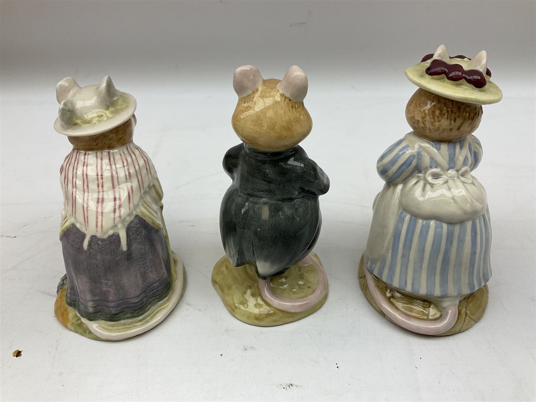 Fifteen Royal Doulton Brambly Hedge figures, comprising Wilfred Toadflax, Dusty Dogwood, Mrs Toadflax, Mr Apple, Primrose Woodmouse, Lord Woodmouse, Poppy Everbright, two Lady Woodmouse, two Old Mrs Everbright, Mr Toadflax, Mrs Apple, Santa Bunnykins and Bunnykins, together with three Royal Albert Wind in the Willows figures comprising Ratty, Badger and Mole, all with printed marks beneath (18)