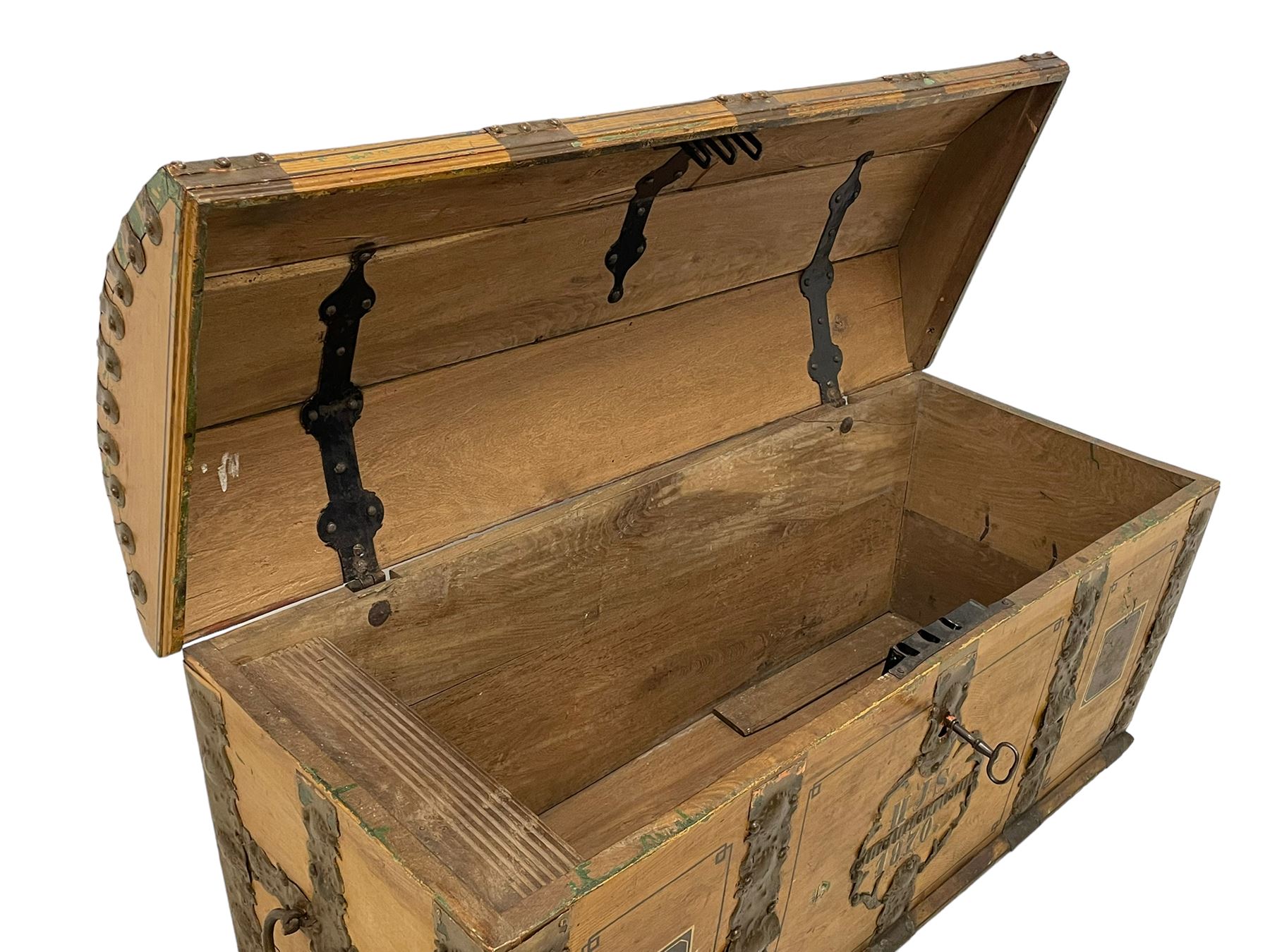 19th century painted oak sea chest, hinged dome top enclosing small compartment, bound by shaped and pressed metal strapwork, scumbled finish to resemble oak and painted with small vignettes depicting portraits and landscapes within panels, fitted with large wrought metal carrying handles, the front inscribed 'H.J.S. 1870' 