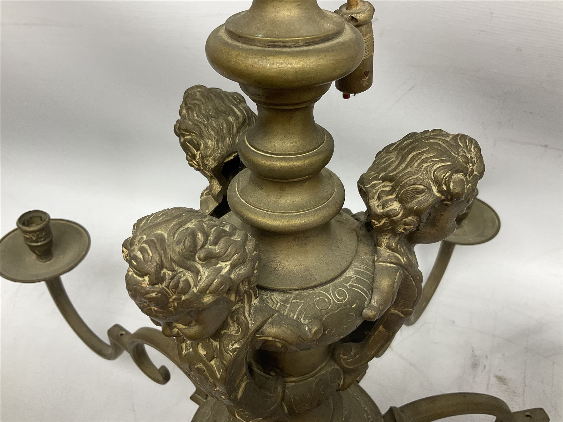 20th century heavy brass eight branch electrolier, detailed with putti masks, approximately H60cm W71cm