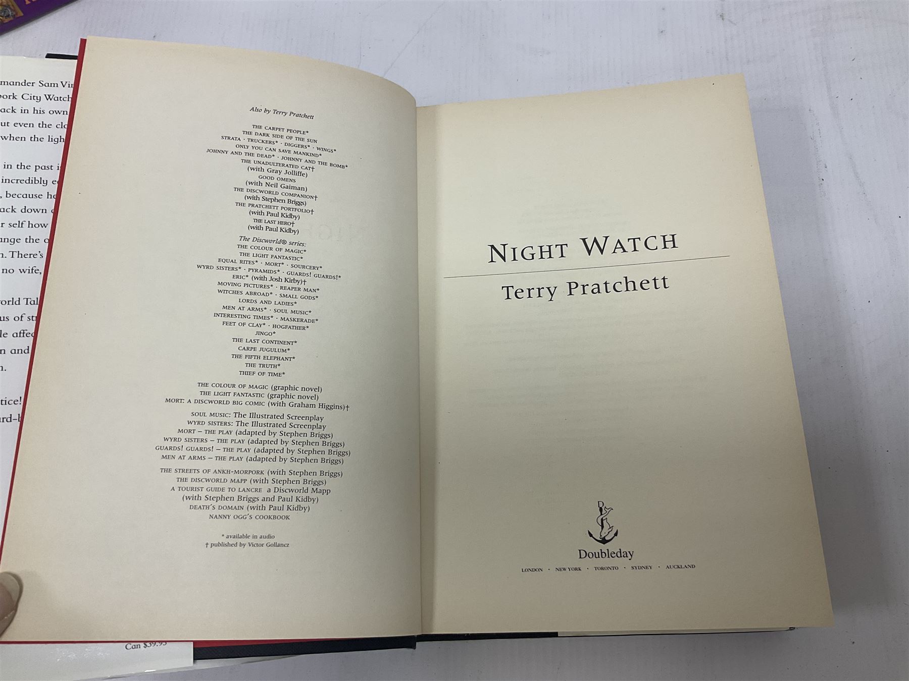 Collection of books by Terry Pratchett, of mostly Discworld interest, to include hardback edition of Going Postal, and further books such as Men at Arms, Sourcery, Small Gods etc 