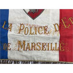 French State Police banner as the tricolor flag embroidered with coloured and metallic thread 'Societe De Secours Mutuels Un Pour Tous Tous Pour Un De La Police D'Eteat De Marseille' to one side; plain flag verso; tassels to three sides 100 x 113cm