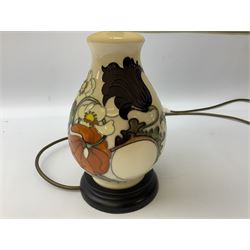 Moorcroft table lamp, of baluster form, decorated with tulips and other flowers upon a white ground with accompanying cream shade of lobed form, with piped detail, H45cm