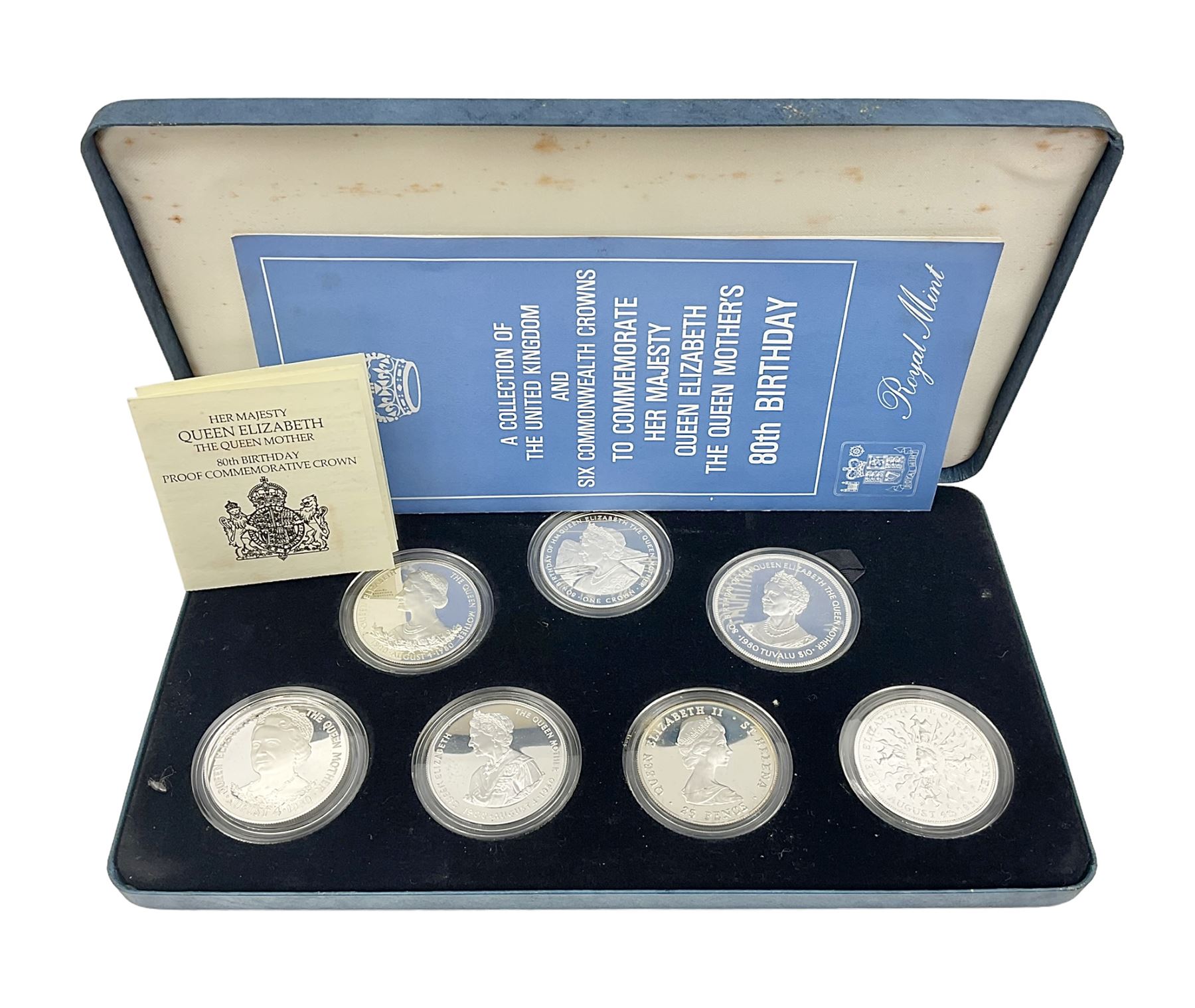 The Royal Mint silver proof seven coin set, comprising United Kingdom and six Commonwealth crowns, commemorating 'Her Majesty Queen Elizabeth The Queen Mother's 80th Birthday', cased with certificate