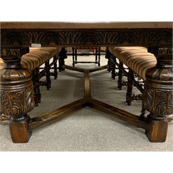 Royal Oak Furniture Co - Jacobean style oak dining table, rectangular top with a lunette carved frieze, acanthus carved baluster cup and cover supports joined by angular stretchers (276cm x 122cm, H81cm), and set ten (8+2) oak framed high back dining chairs upholstered in striped fabric with studded detail, turned supports and stretchers