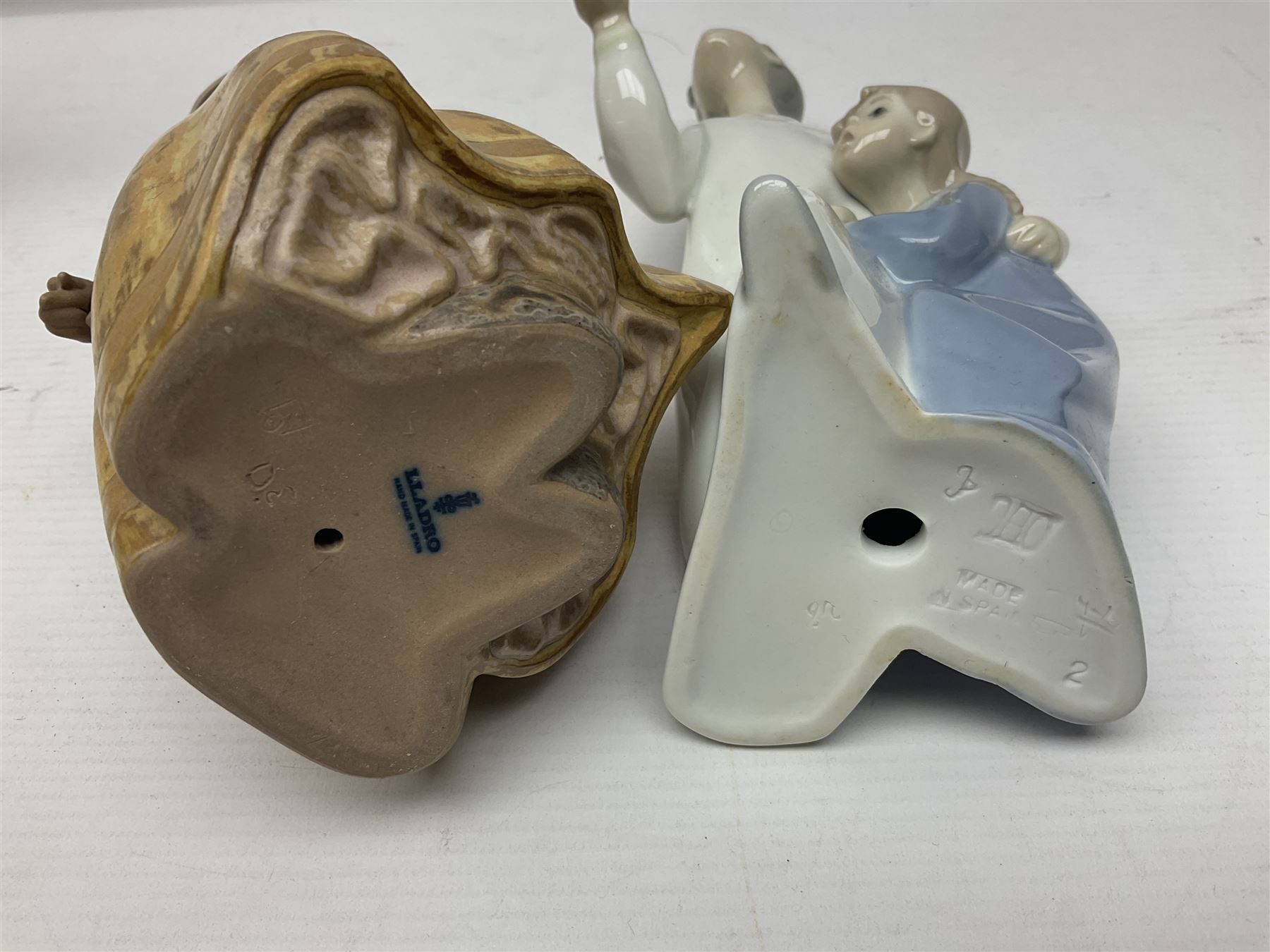 Four Lladro figures, including Girl With Cockerel no 4591, Gres Lonely no 2076 etc together with Nao figure 