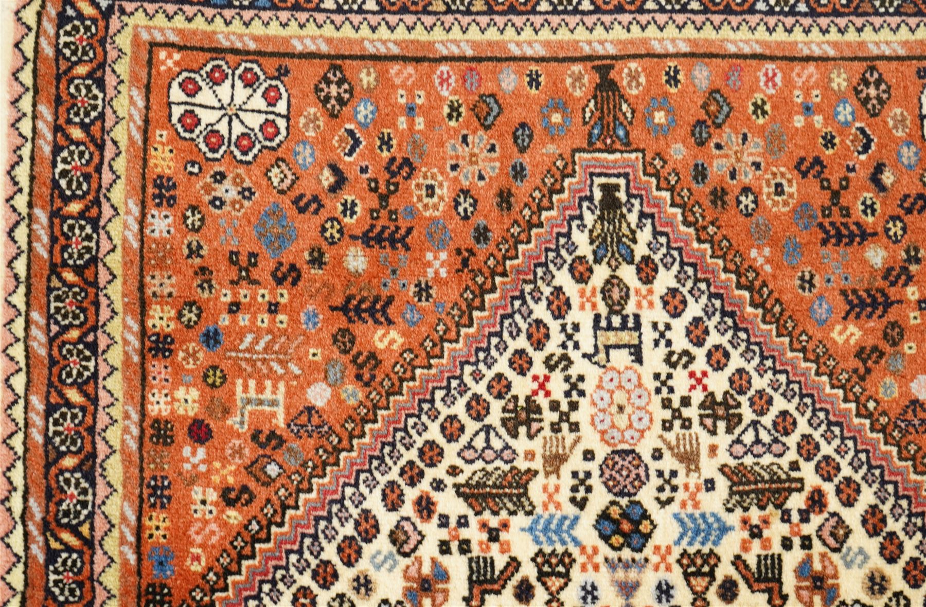 Persian design wool rug, 'Tarange-Lachak' medallion and corner design on a white and pink field framed by pink borders 