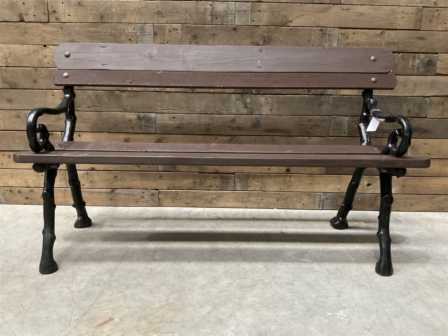 20th century tree cast iron and timber slatted garden bench, black painted frame with stained wood