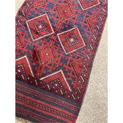 Meshwani runner rug, red and blue ground, repeating medallion and pattern throughout 