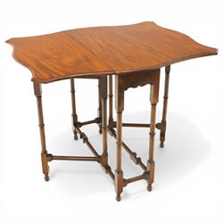 Edwardian mahogany Sutherland table, shaped rectangular drop-leaf top with canted corners and moulded edge, raised on ring-turned gate-leg base united by stretchers