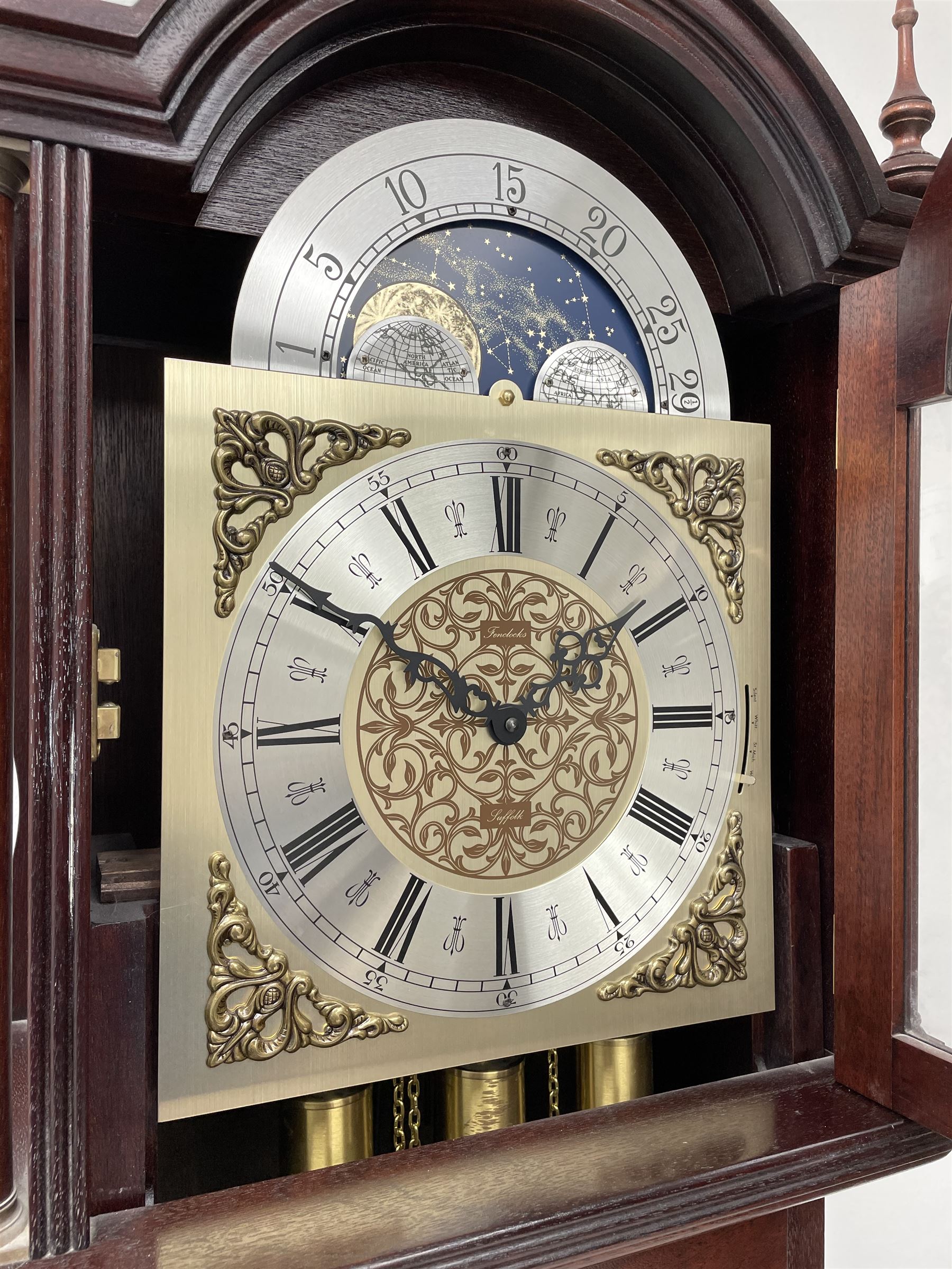 Fenclocks Suffolk - contemporary mahogany longcase clock, stepped arch hood with plain pilaster columns, moon phase dial and silvered Roman chapter ring, with chime set/silent lever, triple weight driven quarter chiming movement