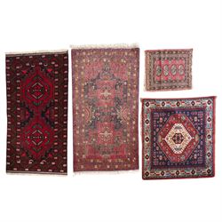 Four small Persian and Caucasian design rugs, comprising a Kazak rug with twin hooked meda...