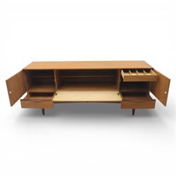 Portwood - Mid 20th century teak sideboard, rectangular top with fall front in the centre flanked by cupboard doors with recessed handles, above four drawers raised on tapered legs