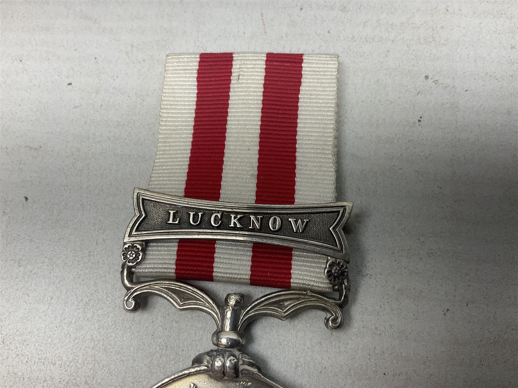 Victoria India Mutiny Medal 1857 - 1858, name erased, with Lucknow clasp and ribbon