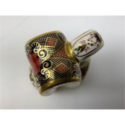 Four Royal Crown Derby paperweights, Llama, with gold stopper, Snake, with gold stopper, Honeybear, with silver stopper and Striped Dolphin, with gold stopper and box, all with printed mark beneath 