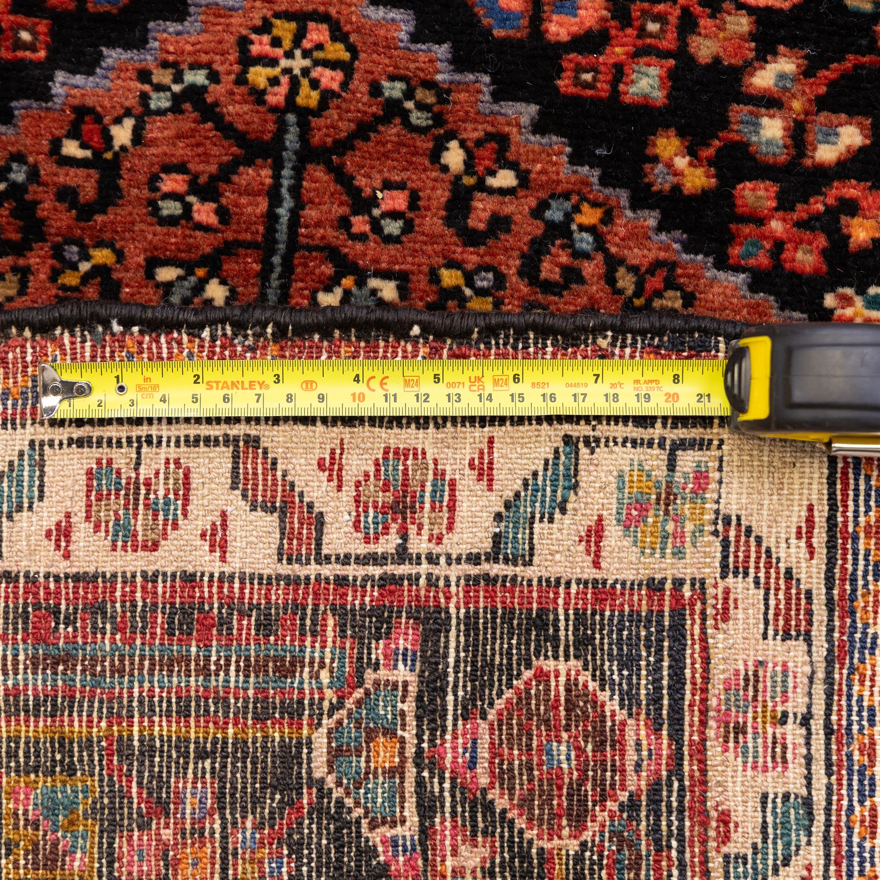 North West Persian Koliahee hand-knotted runner, indigo field with three large linked lozenge medallions in a madder red, framed by angular floral motifs and stylized vines within ivory and terracotta geometric borders, fringe ends  