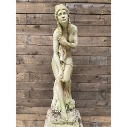 Cast stone garden figure of a bathing lady, raised on square plinth
