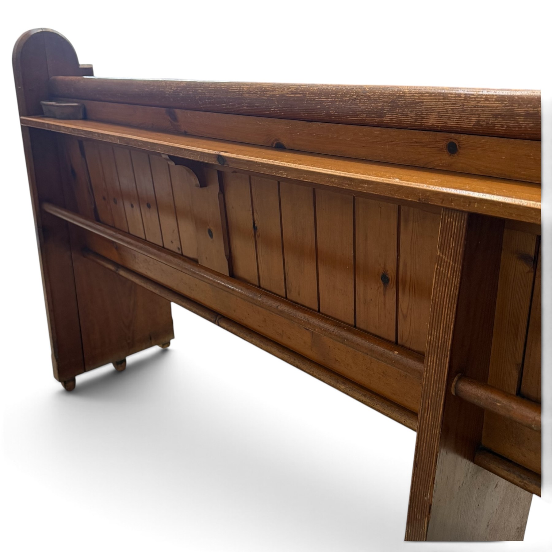 Early 20th century stained pine ecclesiastical church pew, the shaped end supports flanking slatted and panelled back, with black stencilled number '16' to the side