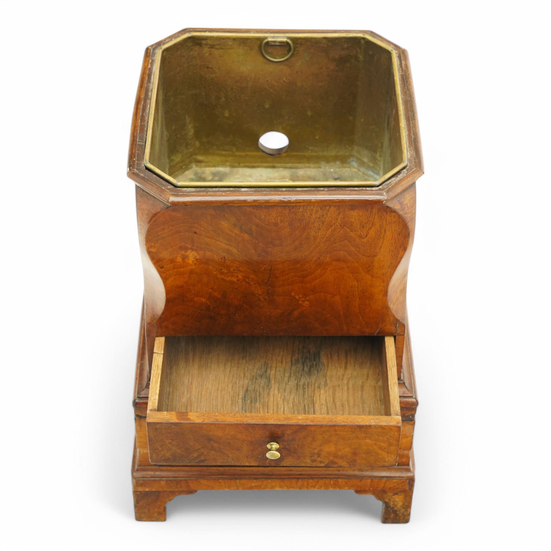 George III figured walnut champagne or wine cooler, of stepped square form with ogee cut-outs, fitted with two drawers, shaped handle plates with engraved decorated to each side, with brass liner, on bracket feet 