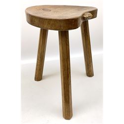 'Rabbitman' oak stool, with dished kidney shaped top carved with rabbit signature, three splayed tapered octagonal supports, by Peter Heap of Wetwang 
