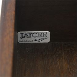 Mid 20th century oak display cabinet, the moulded rectangular cornice above a pair of leaded glazed doors with diamond lattice glazing, enclosing adjustable shelving, the lower section fitted with four short drawers with brass ring handles, flanked by chamfered uprights with carved leaf detail