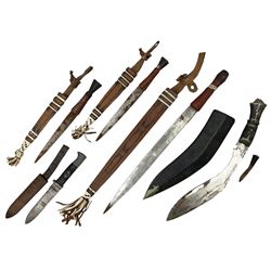 Indian kukri with 29cm curving steel blade and nickel mounted horn grip; in leather covered scabbard with one skinning knife L42cm overall; Hitler Youth knife with scabbard in relic condition; and three African graduated knives each with crudely carved wooden grips and painted leather covered scabbards (5)