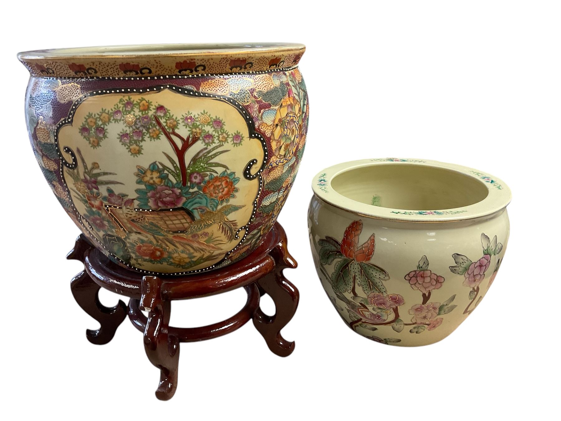20th century Oriental fish bowl jardinière, decorated with reserves of birds amongst flowers, on wooden stand, fish bowl H29cm D36.5cm, together with another smaller example 