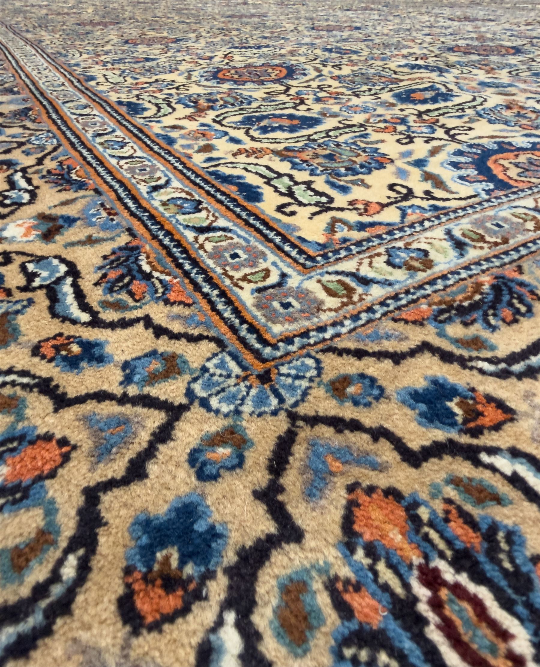 Northwestern Persian Tabriz hand-knotted carpet, the ivory ground with an all-over repeating Herati pattern of stylised palmettes, rosettes and serrated leaves in shades of indigo, terracotta and sky blue, framed by a dark blue border of arabesque vines and scrolling foliage between floral guard stripes, from the region of Tabriz