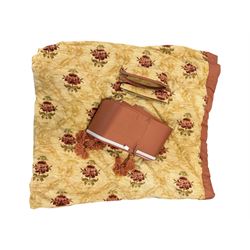 Mid-20th century quilted bedspread and matching valance, the bedspread displaying a warm gold floral pattern with burgundy highlights, complemented by a terracotta fabric trim, together with coordinating terracotta valance with tassels