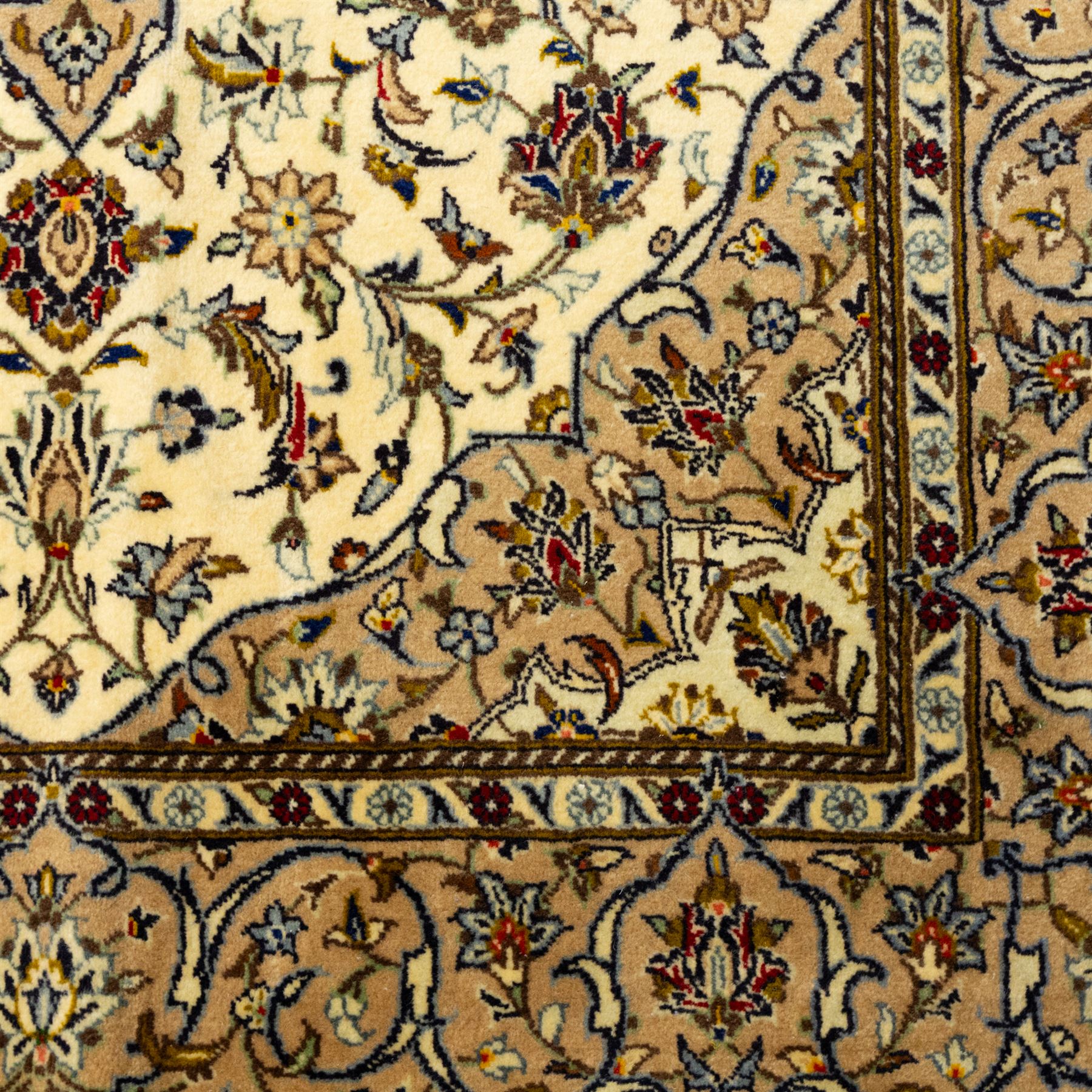 Central Persian Kashan hand-knotted rug, ivory ground, with a central shaped floral medallion with pendants, surrounded by scrolling foliate and floral motifs incorporating rosettes, palmettes and delicate vine work, enclosed by a beige border with repeating palmettes and meandering vines, flanked by narrow floral guard stripes, with cotton fringes