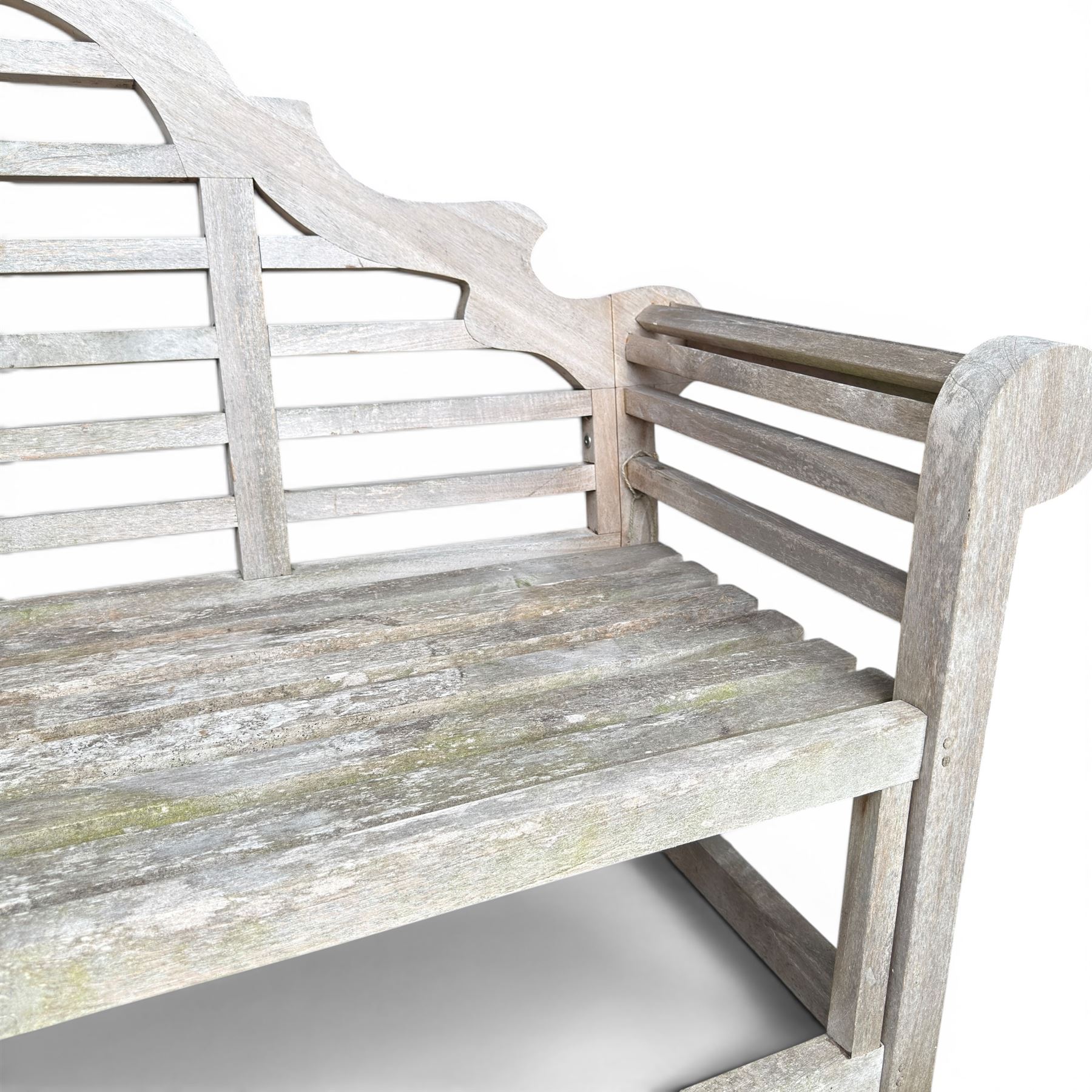 Lutyens design teak garden bench, shaped arched and slatted back over rolled arms and slatted seat, raised on square supports with box-stretcher