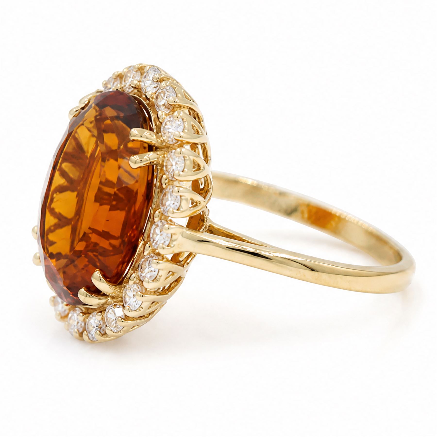 18ct gold citrine and diamond cluster ring, single oval cut citrine of approx 6.90 carat, surrounded by twenty round brilliant cut diamonds, stamped, total diamond weight approx 0.60 carat