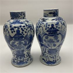 Pair of Chinese blue and white vases, of squat baluster form, each depicting figures holding a ginger jar, with four character Kangxi mark beneath, H13.5cm