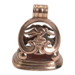 Late 18th/early 19th century 9ct gold fob seal, the carnelian matrix engraved with coat of arms, depicting a shield surmounted by a bird with foliage within its beak, within a scrolling mount detailed with a bird drinking from a chalice, H3.5cm 

Provenance: By family descent from the Chichesters of Arlington Court, Devon; from the collection of Andrew Chichester Everitt.