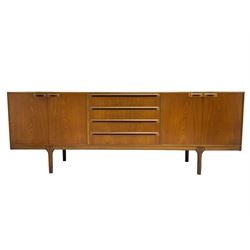 Tom Robertson for AH McIntosh & Co of Kirkaldy - mid-20th century teak sideboard, fitted with four central drawers, flanked by cupboard enclosing shelves and sliding tray, raised on cylindrical supports