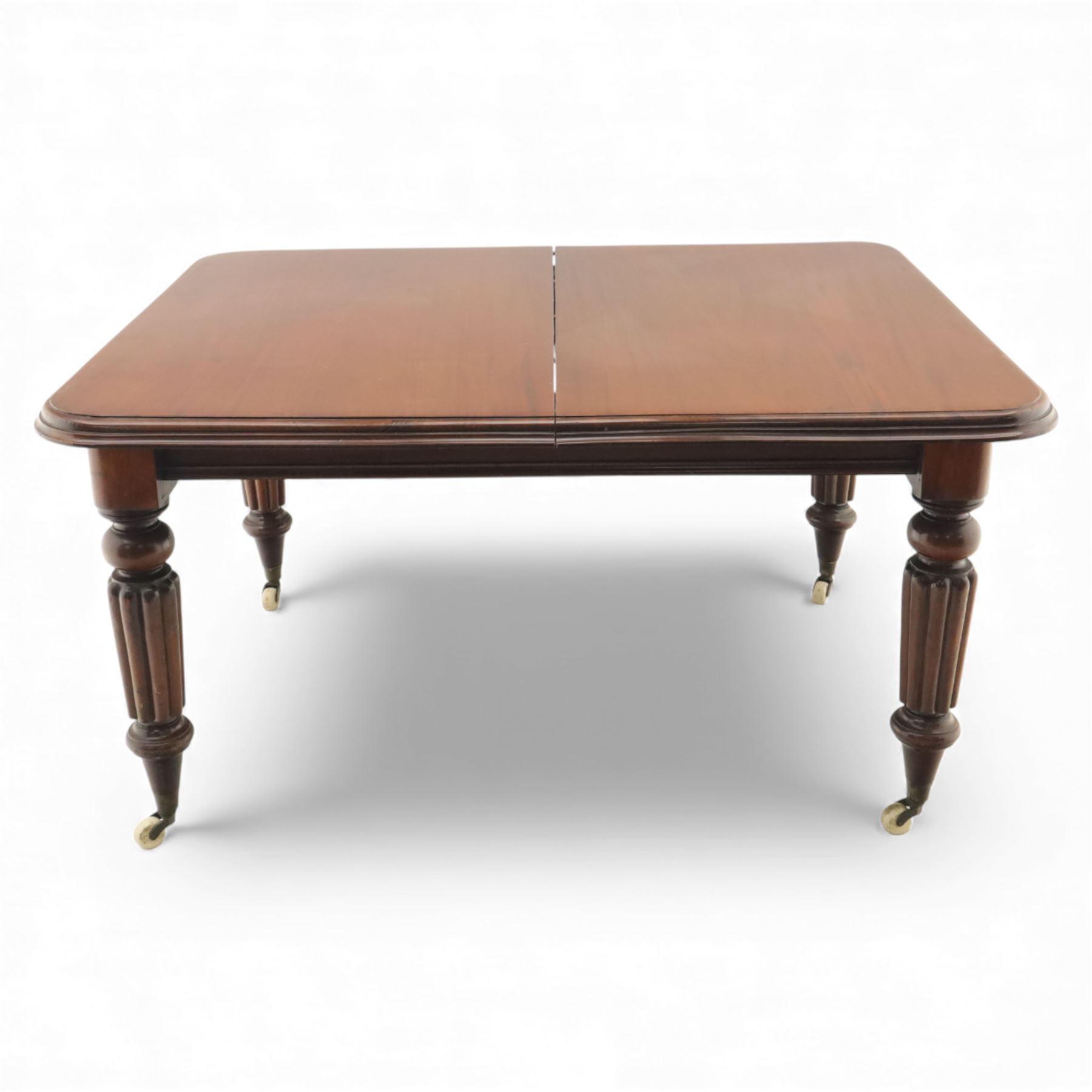 Large Victorian mahogany dining table, rectangular telescopic top with two additional leaves, upon turned knopped and reeded legs with ceramic casters, (Extends to 230cm)