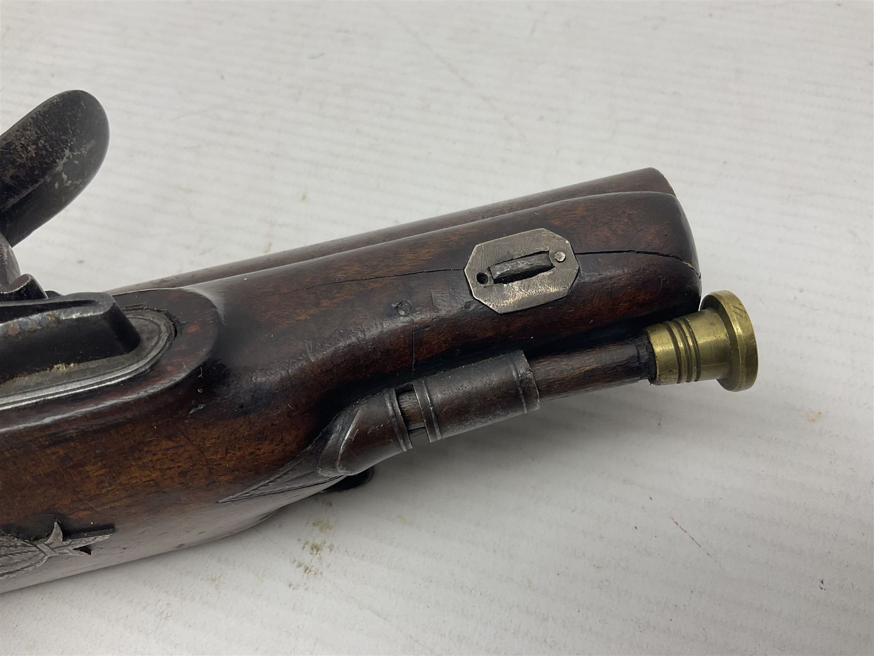 Early 19th century Wm. Hollis flintlock belt or pocket pistol, approximately 20 bore, the 10cm barrel with ram rod under, engraved lock plate with maker's name and roller frizzen, engraved trigger guard with pineapple finial and walnut stock with chequered grip L25cm overall