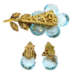 Miriam Haskell gilt blue crystal and paste stone set flower brooch and a similar pair of clip on earrings 
