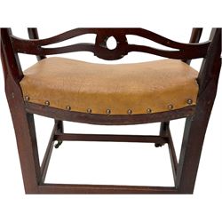 Georgian mahogany elbow chair, the shaped cresting rail over a series of pierced waved horizontal rails, shaped arms and carved supports, dished upholstered seat, moulded supports with later castors 